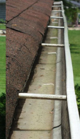 After: Leaf dam and standing water removed, gutter re-sloped so it empties to the downspout.